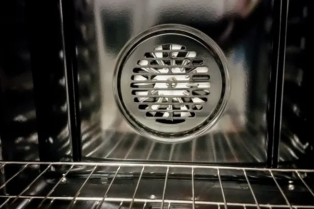 Close-up of a Thermador oven cooling fan grille inside the oven cavity