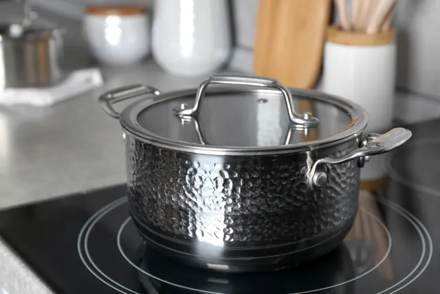 Stainless steel pot sitting on an induction stove not working in a kitchen