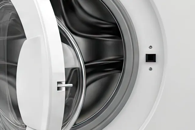Close-up of an open front-load washer door and latch on a washing machine that won't start